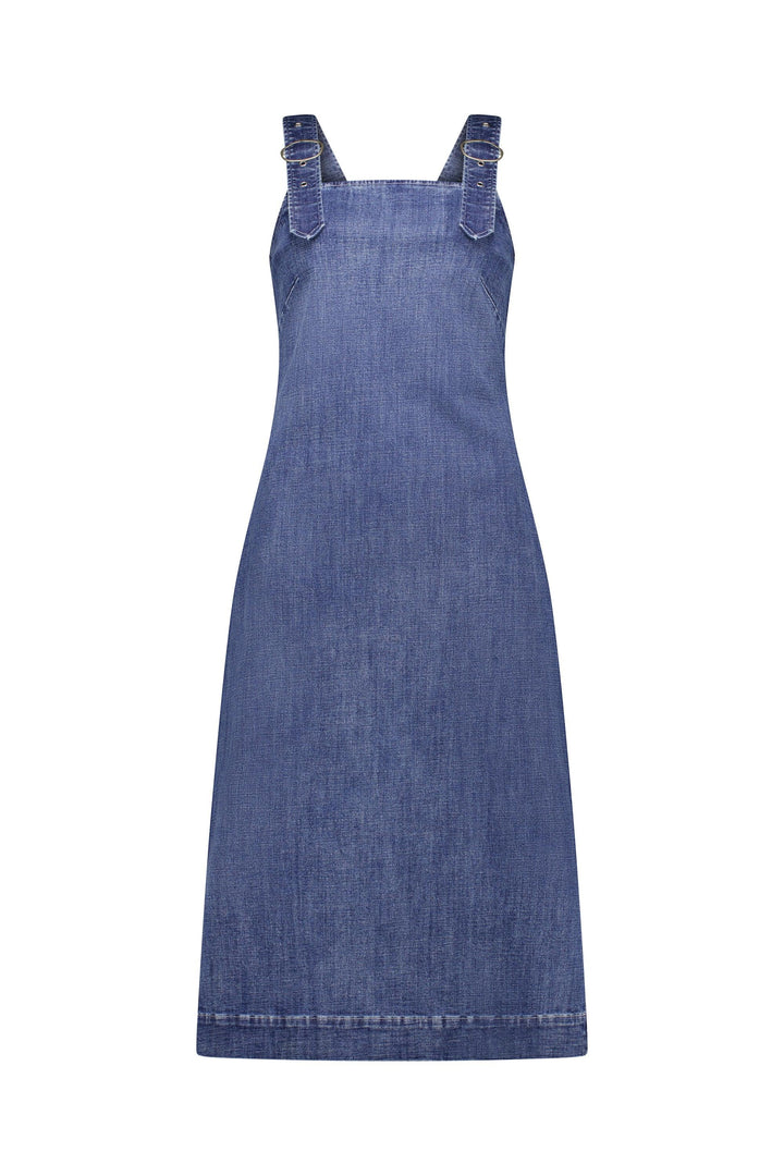 The Academy Dress - Mid Wash by Knewe Label is a sleeveless denim dress with wide pinafore straps, a straight, gently flared fit, and visible seam stitching for a minimalist look. Made from stretch denim.
