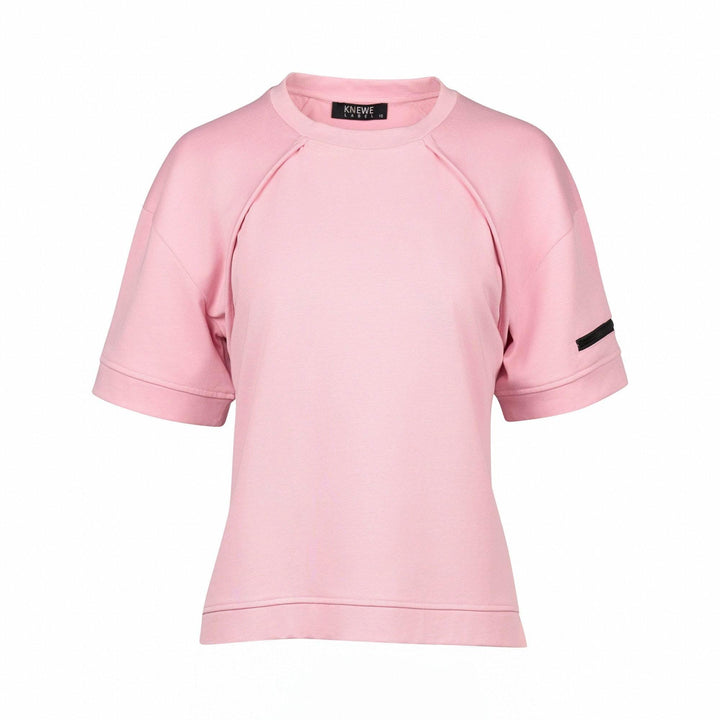 Light pink short sleeve women's tee with black arm detail and relaxed fit on white background