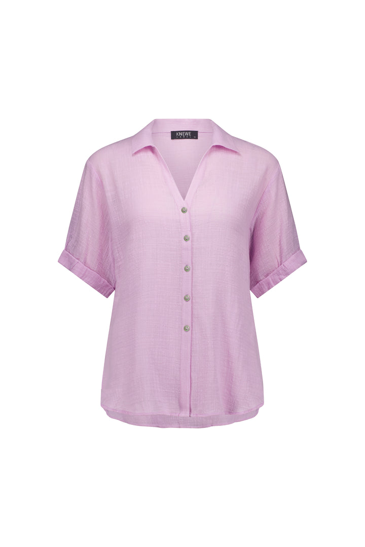 The Knewe Label Infinity Shirt - Lilac features a relaxed fit, folded cuffs, and lightweight textured cotton. This short-sleeve collared button-up blouse is shown on a plain white background.