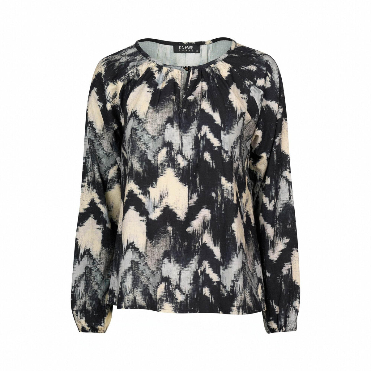 Long sleeve blouse with abstract black, white, and beige print, round neckline.