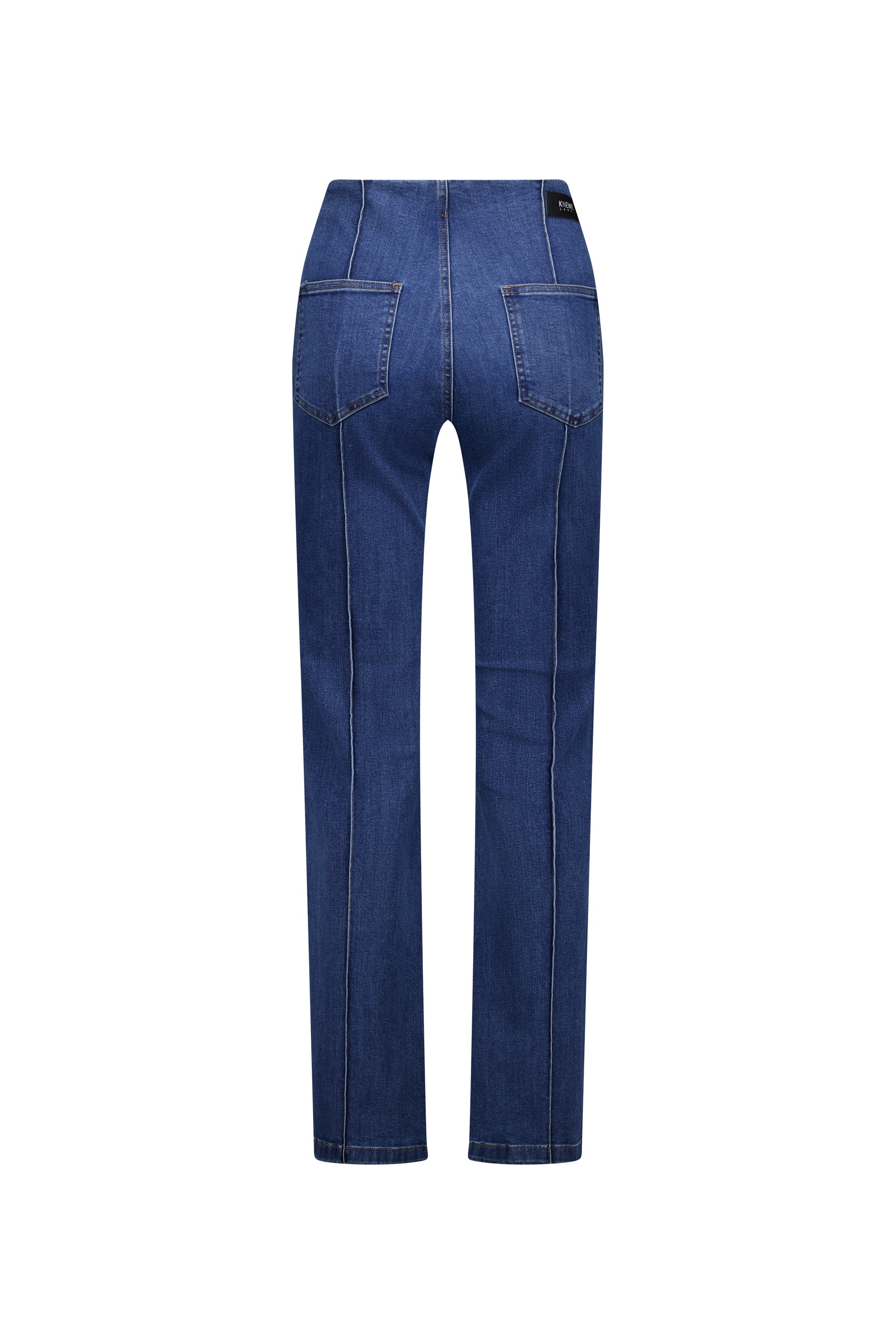 The Knewe Label Haze Jean - Indigo is shown from the back, featuring two large back pockets, visible seams, and a straight-leg cut in stretch denim against a white background.