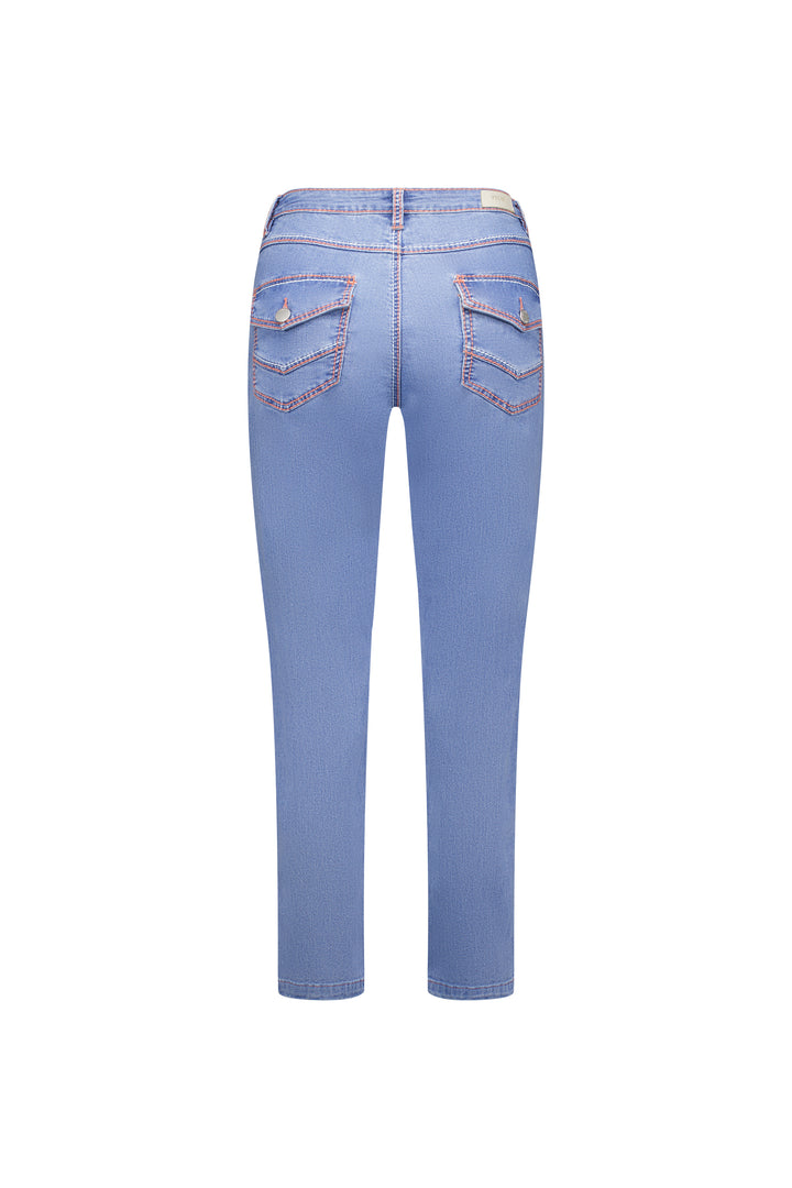 Flat lay back view of the Knewe Label Switch Jean in palm blue stretch denim, showing the straight-leg ankle-grazer cut, flap back pockets with metal button closures, contrast stitching and leather KNEWE brand patch on the waistband.