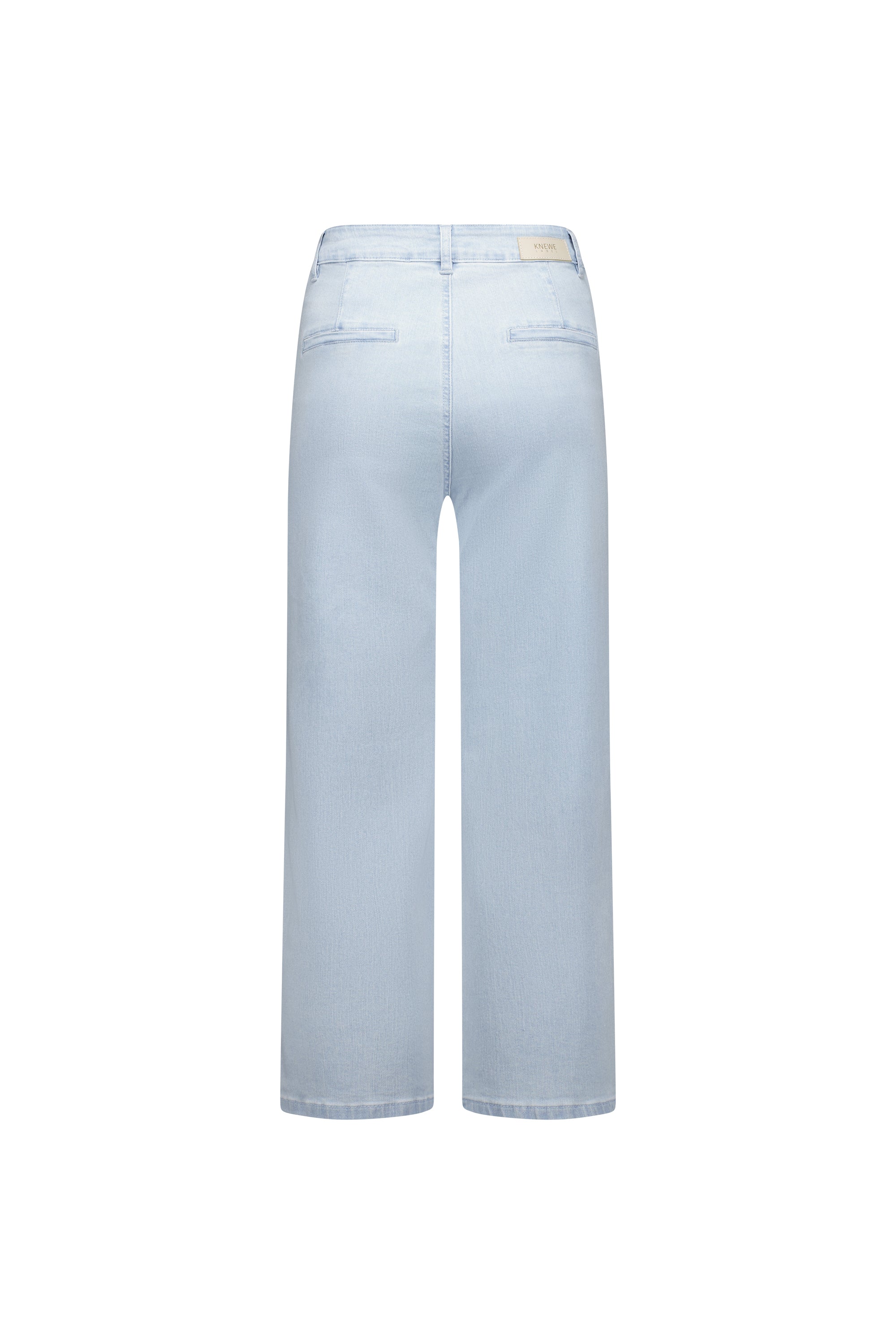 Flat lay back view of the Knewe Label Club Jean in light wash stretch denim, showing the clean rear panel, faux welt back pockets and leather KNEWE brand patch at the waistband against a white background.