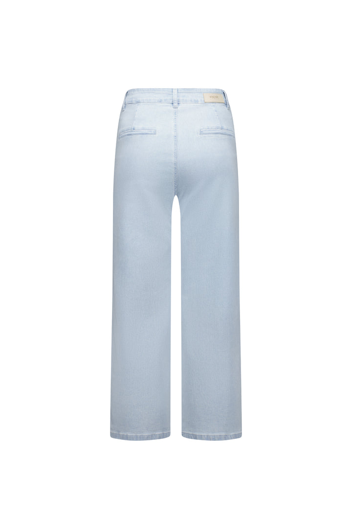 Flat lay back view of the Knewe Label Club Jean in light wash stretch denim, showing the clean rear panel, faux welt back pockets and leather KNEWE brand patch at the waistband against a white background.