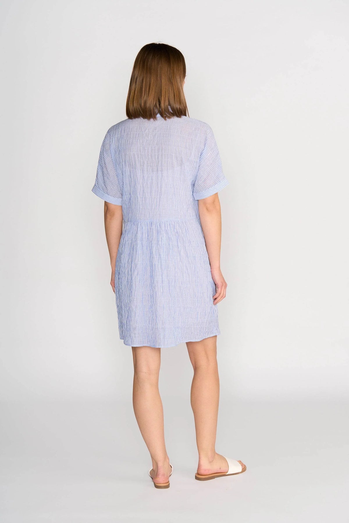 Back view of a woman wearing a blue striped short-sleeve cocoon dress