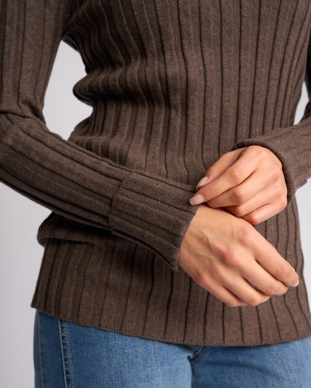 Close-up of the cuffed sleeve of the Knewe Label Felix Cuffed Sweater in Truffle brown.